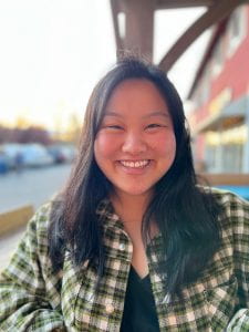 Picture of Lilyanna Sullivan, a queer Chinese adoptee, smiling.