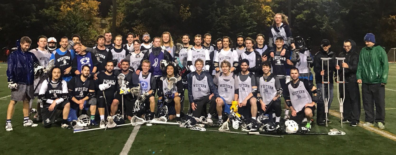 Men's Lacrosse alumni pose for photo with current players