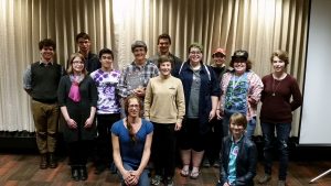 A picture of a group of out in science students and faculty and guests with astronaut Wendy Lawrence and her partner, taken in 2016.