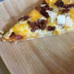 yellow, white and brown pizza on wood pattern plate