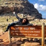 Student poses next to "Cape of Good Hope" sign