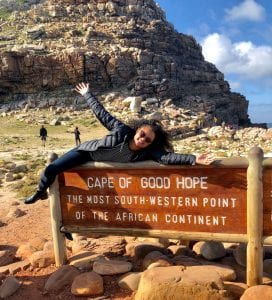 Student poses next to "Cape of Good Hope" sign