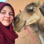 Student poses with a camel