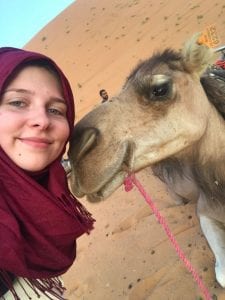 Student poses with a camel
