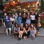 Student group photo in front of restaurant