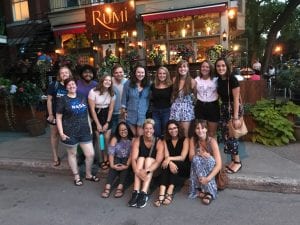 Student group photo in front of restaurant