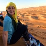 Student in front of desert landscape