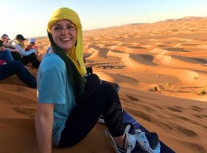 Student in front of desert landscape