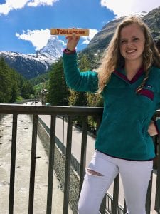 Student holds "Toblerone" candy in front of Matterhorn mountain