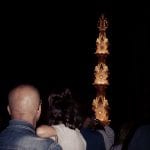 Visitors observe a lighted tower