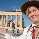 Student stands by the Parthenon