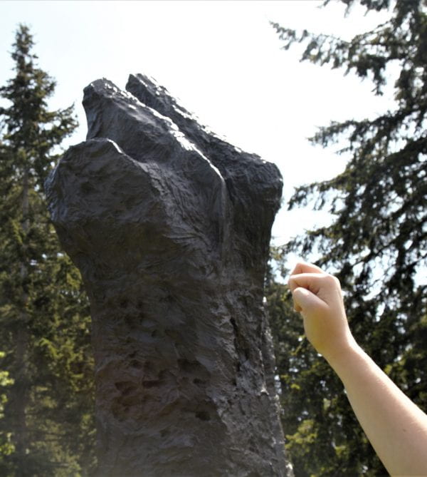 Manus sculpture and human hand showing fisted resebalence