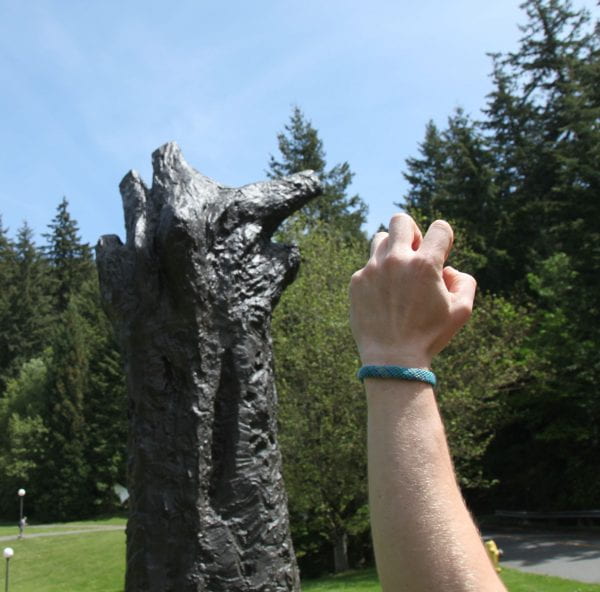 Manus sculpture and human gripping hand to show resembalence