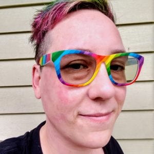 Kat Ray king has multi-colored rainbow hair with matching glasses